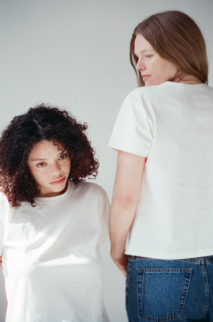 Two women wearing white t-shirts and blue jeans against a plain background. T-shirts are 100% cotton and UPF 40+ sun protection.